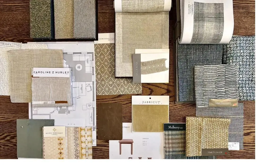 Fabric swatches and material samples arranged on a wooden surface